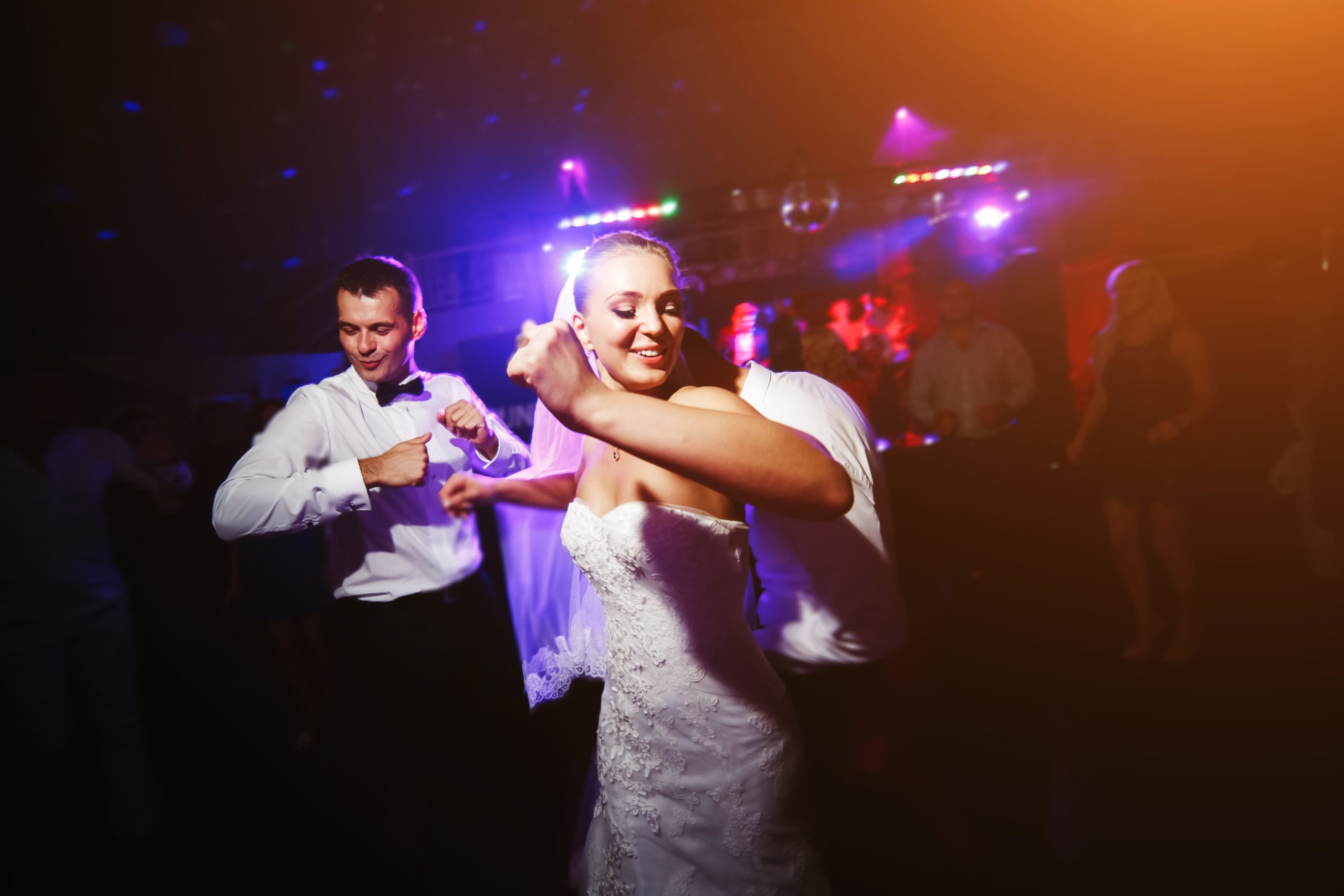bride and groom encourage others to dance at their wedding